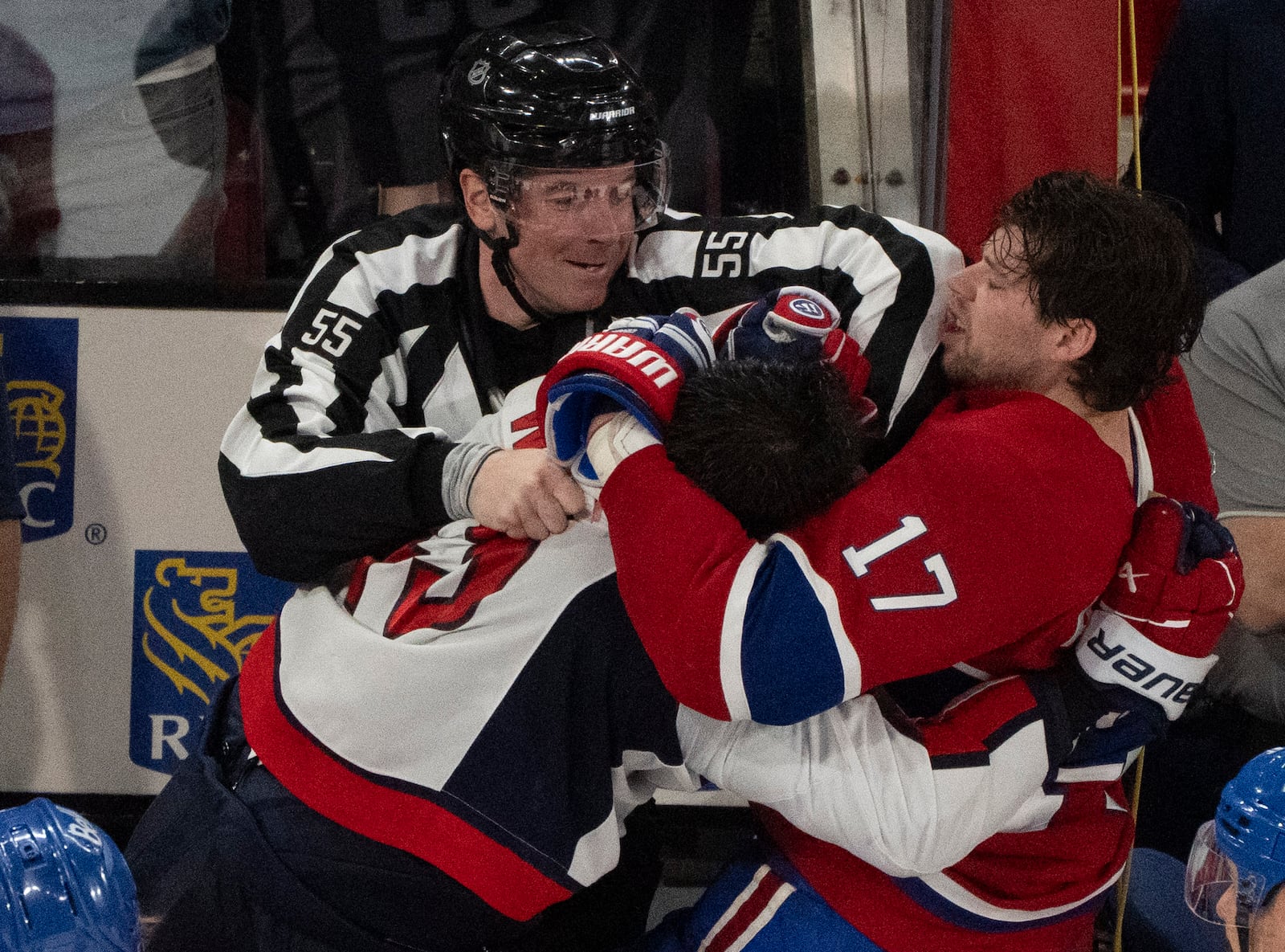 A referee (55) tries to separate Montreal Canadiens' Josh Anderson (17) and Washington Capitals' Tom Wilson, front left, as they fight following the second period of Game 3 of a first-round NHL hockey playoff series in Montreal, Friday, April 25, 2025. (Christinne Muschi/The Canadian Press via AP)