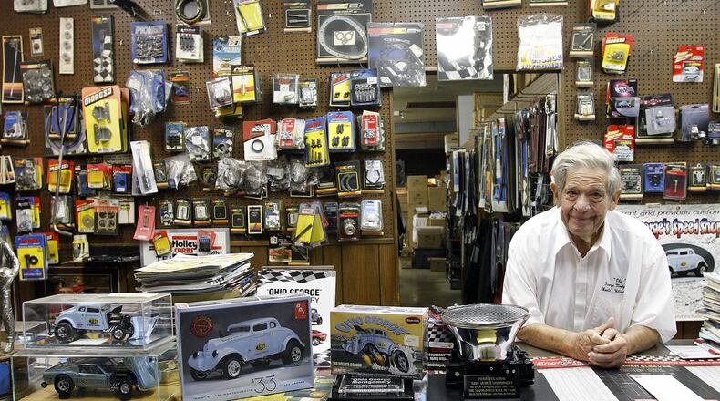 ‘Ohio George’ Montgomery leans on the counter at his speed shop in Dayton Oct. 21. On the left are model car kits of his 1933 Willys Gasser. © 2019 Photograph by Skip Peterson