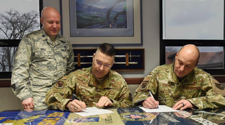 Lt. Col. William Holl, Air Force Assistance Fund installation project officer, explains the Air Force Assistance Fund contribution form to Col. Thomas Sherman, 88th Air Base Wing commander, and Chief Master Sgt. Stephen Arbona, 88 ABW command chief. (U.S. Air Force photo/Tech. Sgt. Ashley Clingerman)