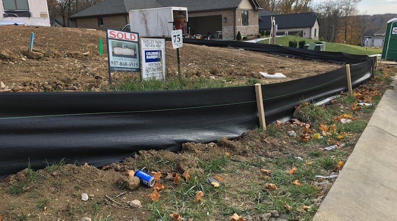 Black skirting is installed to prevent runoff at construction sites in the Highview Terrace residential development by Clemens Companies in Bellbrook. RICHARD WILSON/STAFF