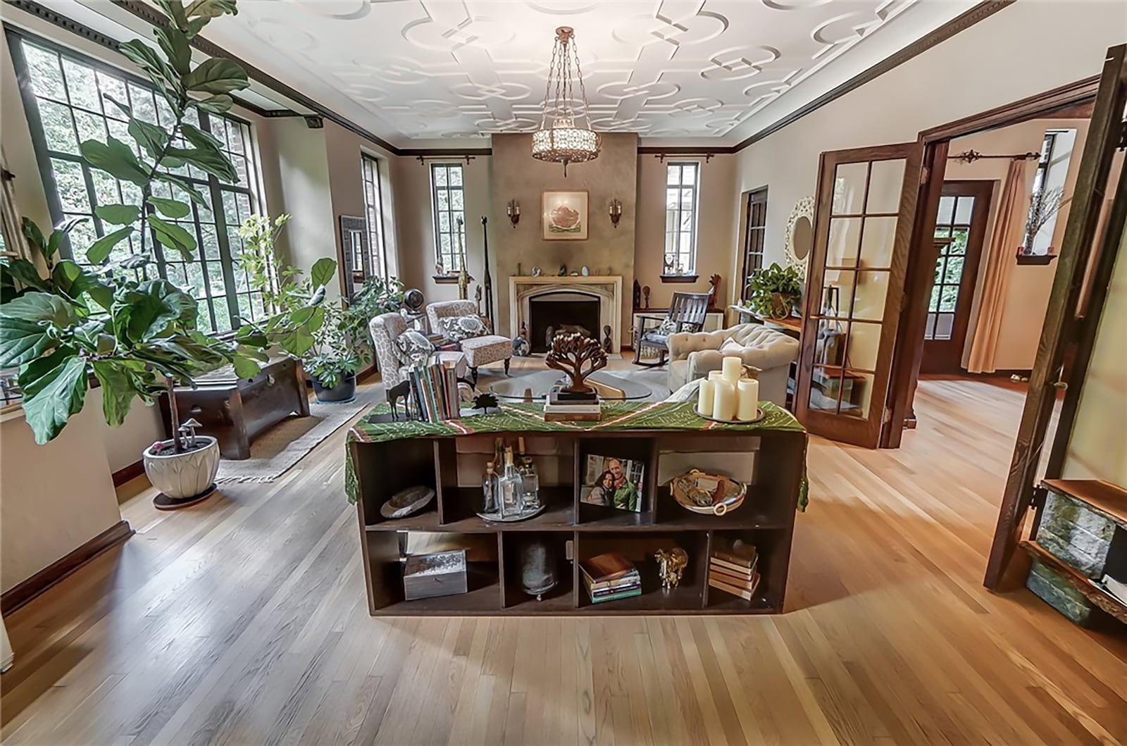 The family room is at the front of the house and has hardwood floors, a fireplace, a decorative plaster ceiling, crown molding and a chandelier. CONTRIBUTED