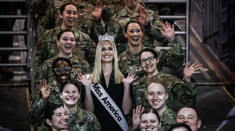 Miss America and a USAF Second Lt. Madison Marsh poses with other airmen at the US Air Force Museum on Tuesday March 19, 2024. Marsh toured the museum and took questions from attendees. JIM NOELKER/STAFF