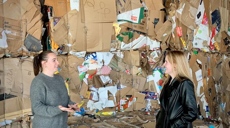 Rumpke’s Molly Kennedy (left) and MaKara Blake (right) of Greene County Environmental Services in front of a collection of cardboard to be recycled at the county facility on Greene Way Blvd. Recycling facilities such as this see lots of cardboard after Christmastime, which will be turned into new material goods. LONDON BISHOP/STAFF