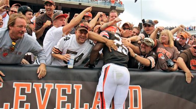 Cleveland Browns running back Chris Ogbonnaya (25) leaps into the Dawg Pound after a 1-yard touchdown catch against the Cincinnati Bengals in the fourth quarter of an NFL football game on Sunday, Sept. 29, 2013, in Cleveland. (AP Photo/Tony Dejak)