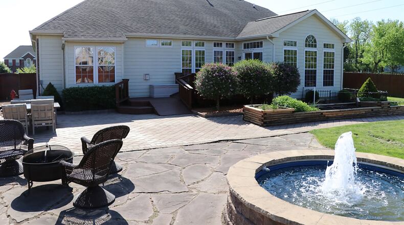 The morning room has panoramic views of the private back yard, a cathedral ceiling and patio doors that open to a 2-level wooden deck with ramps and steps. The double deck leads down to a paver brick patio, which is extended out to a water feature, fountain or soak pool.