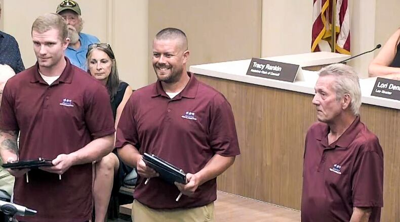 West Carrollton Service Department employee Nick Kolb, Supervisor Todd Pemberton and Service Department employee Billy Branham accept West Carrollton Police Department’s new Patrick M. McCoy award at West Carrollton City Council meeting Tuesday, July 12, 2022. (Not pictured is former Service Department employee Matt Gustin.) The award is to be given to a city of West Carrollton employee “for a specific act, series of acts or conduct that is considered to be outstanding." CONTRIBUTED