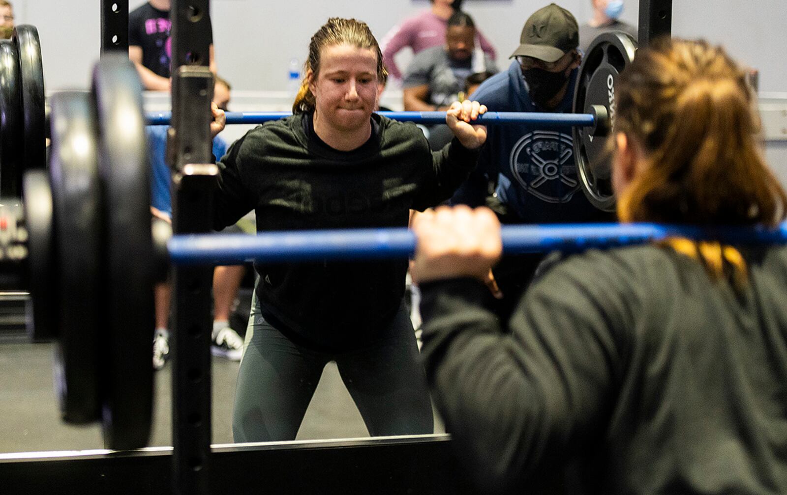 Sierra Dehart, Air Force Institute of Technology, performs a squat during the powerlifting competition Dec. 11 at Wright Field Fitness Center. Dehart, who said she had not trained for the event, went on to win the women’s division. U.S. AIR FORCE PHOTO/R.J. ORIEZ