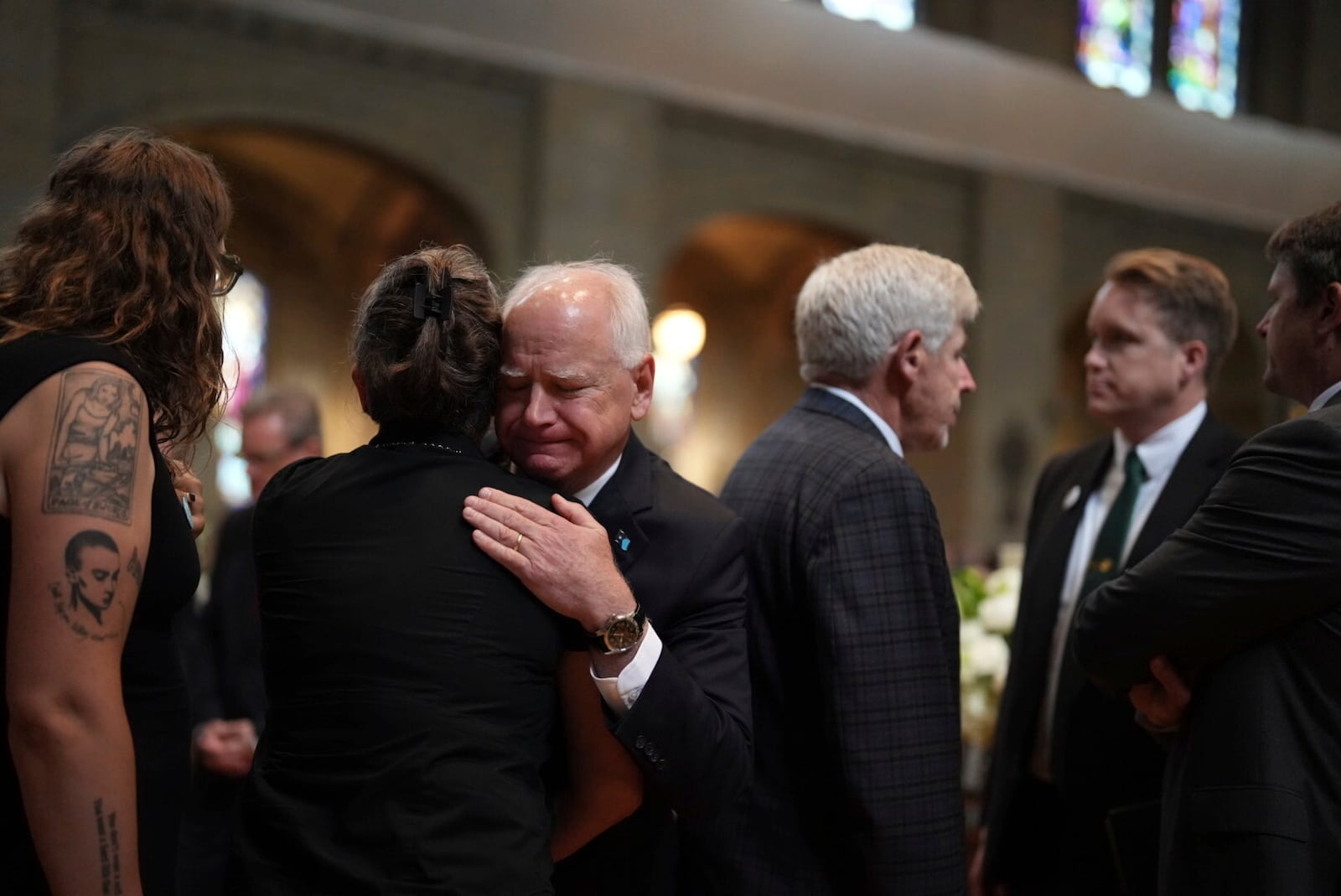 Gov. Tim Walz greets attendees before funeral services for Mark and Melissa Hortman at the Basilica of St. Mary in Minneapolis, Minn., on Saturday, June 28, 2025. (Alex Kormann/Star Tribune via AP, Pool)