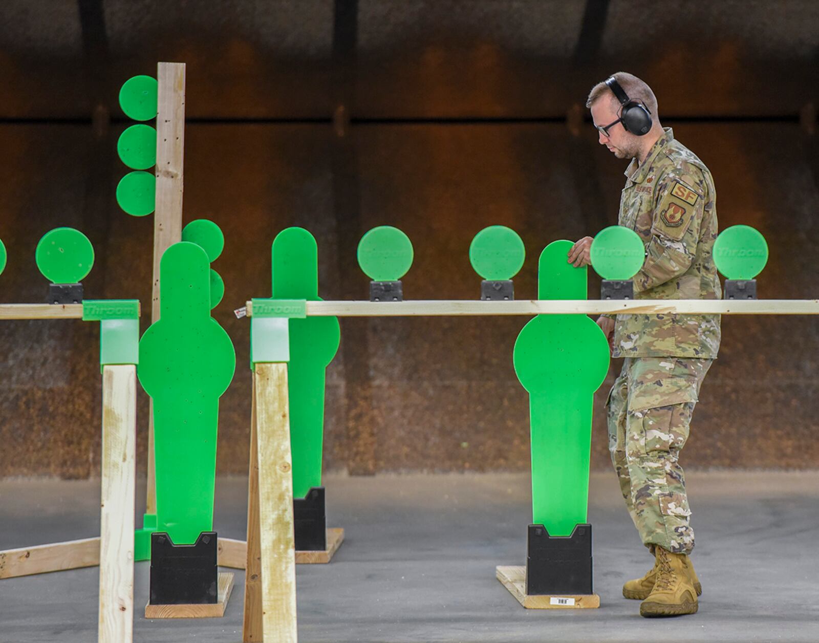 Tech. Sgt. Shane Ruark, 88th Security Forces Squadron training NCO in charge, sets up shooting targets July 22 at the indoor firing range on Wright-Patterson Air Force Base. U.S. AIR FORCE PHOTO/MATTHEW CLOUSE