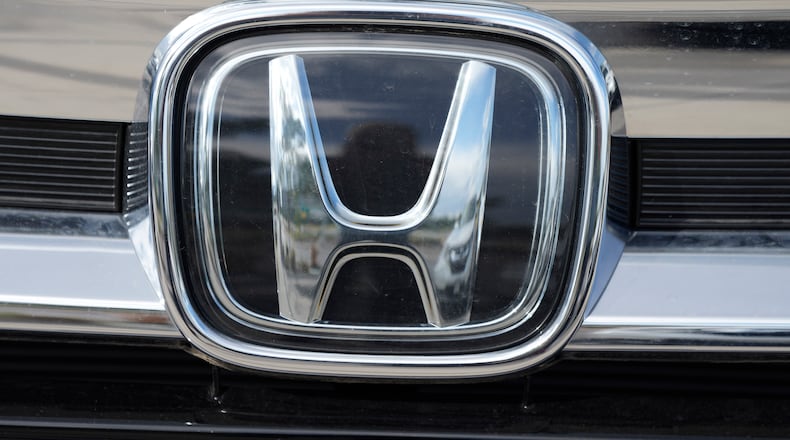 The company logo shinesoff the grille of an unsold 2021 Pilot sports-utility vehicle outside a Honda dealership Sunday, Sept. 12, 2021, in Highlands Ranch, Colo. Honda is recalling nearly 723,000 SUVs and pickup trucks, Friday, Dec. 3, because the hoods can open while the vehicles are moving. The recall covers certain 2019 Passports, 2016 through 2019 Pilots and 2017 through 2020 Ridgeline pickups. (AP Photo/David Zalubowski)
