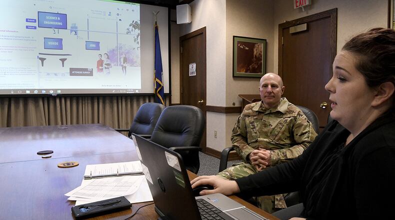 Maj. Gen. Carl Schaefer, deputy commander, Air Force Materiel Command, receives a demonstration from Danielle Hendershott during AFMC’s first virtual hiring event at Wright-Patterson Air Force Base, April 10. The online event received over 4,000 pre-registrations, and during the event, prospective employees engaged in the various ‘booths’ aligned with employment categories, such as science and technology. (U.S. Air Force photo/Scott M. Ash)
