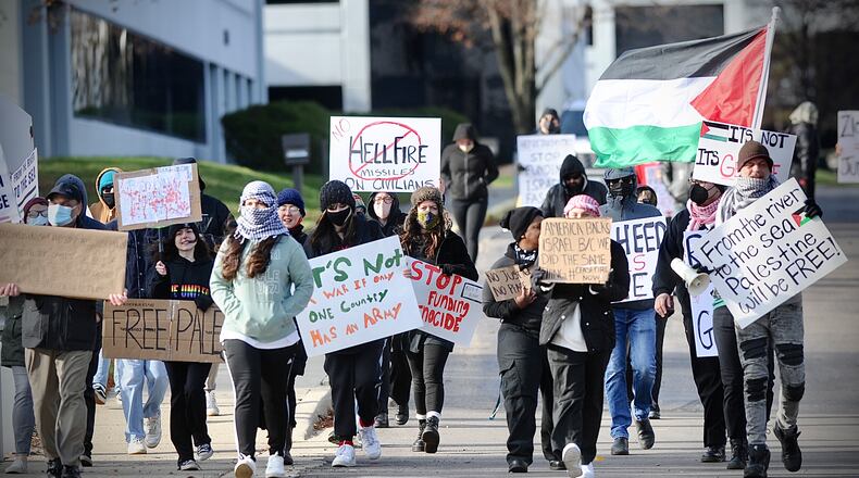 Protesters march Friday, Nov. 24, 2023, in Fairborn to end the violence against Palestinians. MARSHALL GORBY \STAFF