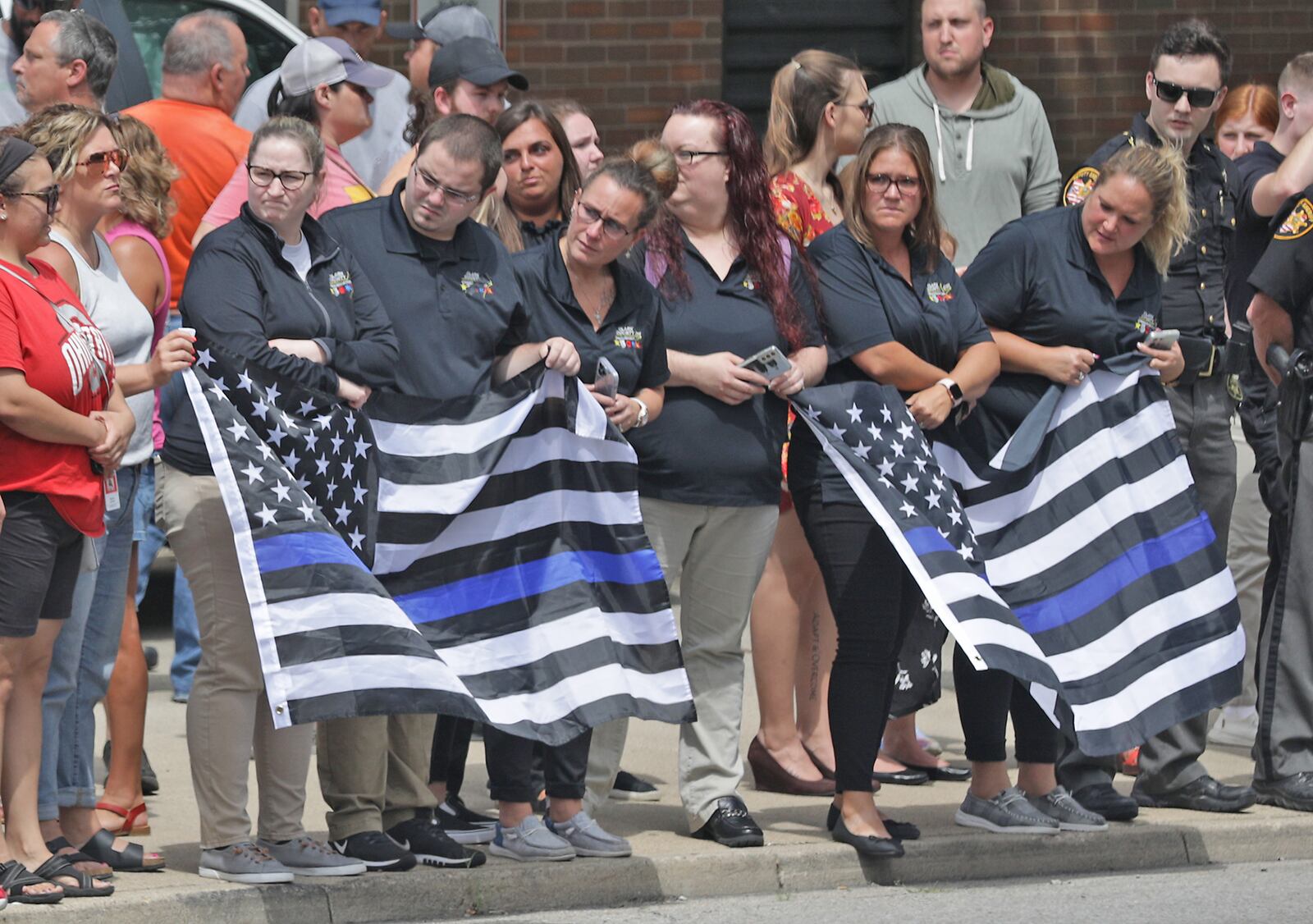 The Clark County community showed up to pay their respects to Deputy Matthew Yates, whose body was returned to Springfield in a Sheriff's Special Operations vehicle Monday afternoon. Yates, was escorted by a procession of law enforcement vehicles. He was shot Sunday while responding to a call at Harmony Estates mobile home park. BILL LACKEY/STAFF
