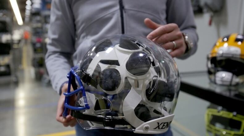 President of Xenith, Ryan Sullivan, points out different parts of a helmet at the Xenith factory Tuesday, April 25, 2017 in Detroit. Xenith makes high-tech football helmets, shoulder pads and other safety equipment. (Elaine Cromie/Detroit Free Press/TNS)