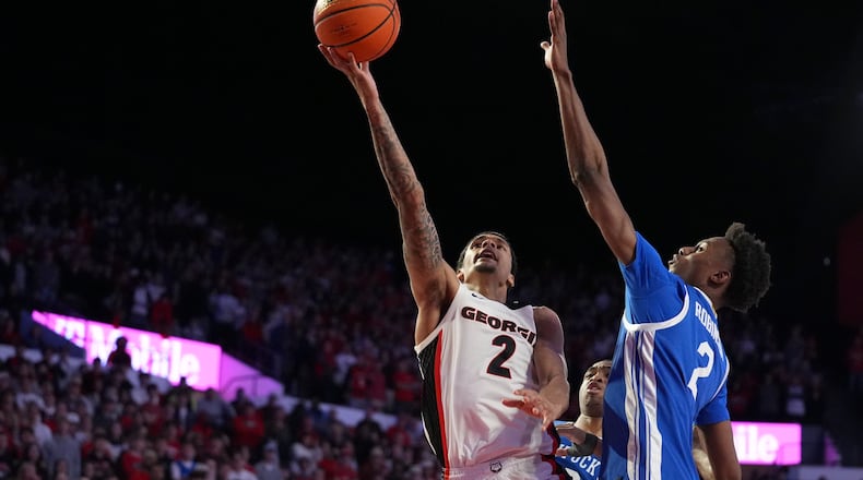 Georgia guard De'Shayne Montgomery (2) shoots the ball against Kentucky guard Jaxson Robinson (2) during the second half of an NCAA college basketball game, Tuesday, Jan. 7, 2025, in Athens, Ga. (AP Photo/Brynn Anderson)
