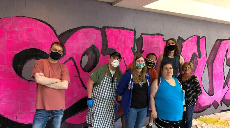 A mural project created by artists with developmental disabilities will be completed soon at Montgomery County Board of Developmental Disabilities Services. The artists, Tyler Garrett, Kent Cruea, Alicia Vencill, Carlton Canady and Kaitlyn Daugherty, collaborated with members of the community to create six  murals. Left to right: Tyler Garrett, Kent Cruea, Alicia Vencill, Carlton Canady, Kaitlyn Daugherty, Hailey Fulford, artist in residence and  Brenda Michel, program support professional.
 CONTRIBUTED PHOTO