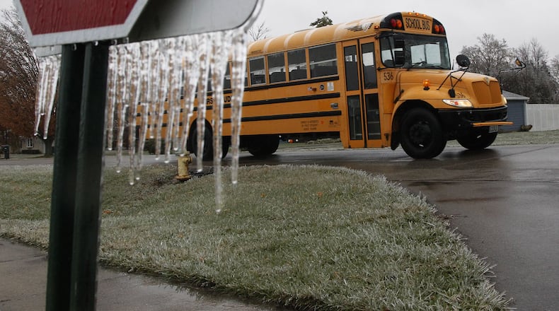 A Xenia school bus returns to the bus lot when school was cancelled due to freezing rain conditions this winter. The number of calamity days school districts have taken this year varies widely due to the flexibility they now have to meet state education hour requirements. TY GREENLEES / STAFF