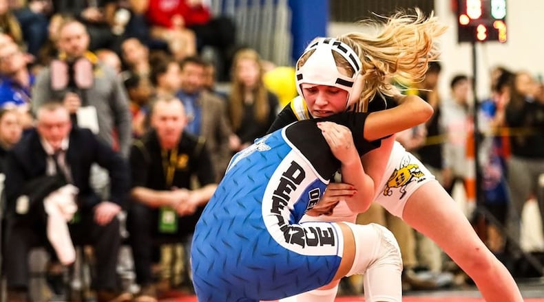 Sidney s Josie Davis (white singlet pictured here during 2020 tournament) won her third state at the Ohio High School Wrestling Coaches Association girls state wrestling championships Sunday at Hilliard Davidson High School. Kevin Bowyer Photography / Contributed