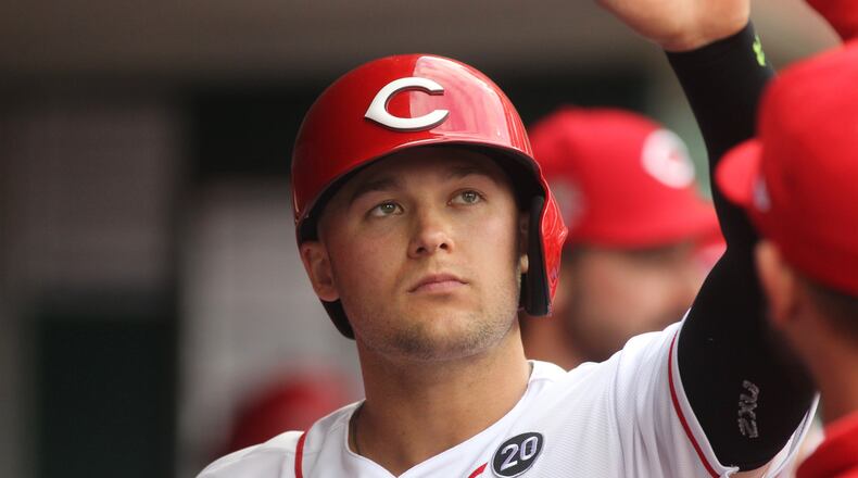 The Reds’ Nick Senzel slaps hands with teammates in the dugout after scoring against the Cubs on Wednesday, May 15, 2019, at Great American Ball Park in Cincinnati. David Jablonski/Staff