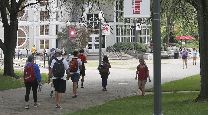 Students walk across campus at Wittenberg University Tuesday. Bill Lackey/Staff
