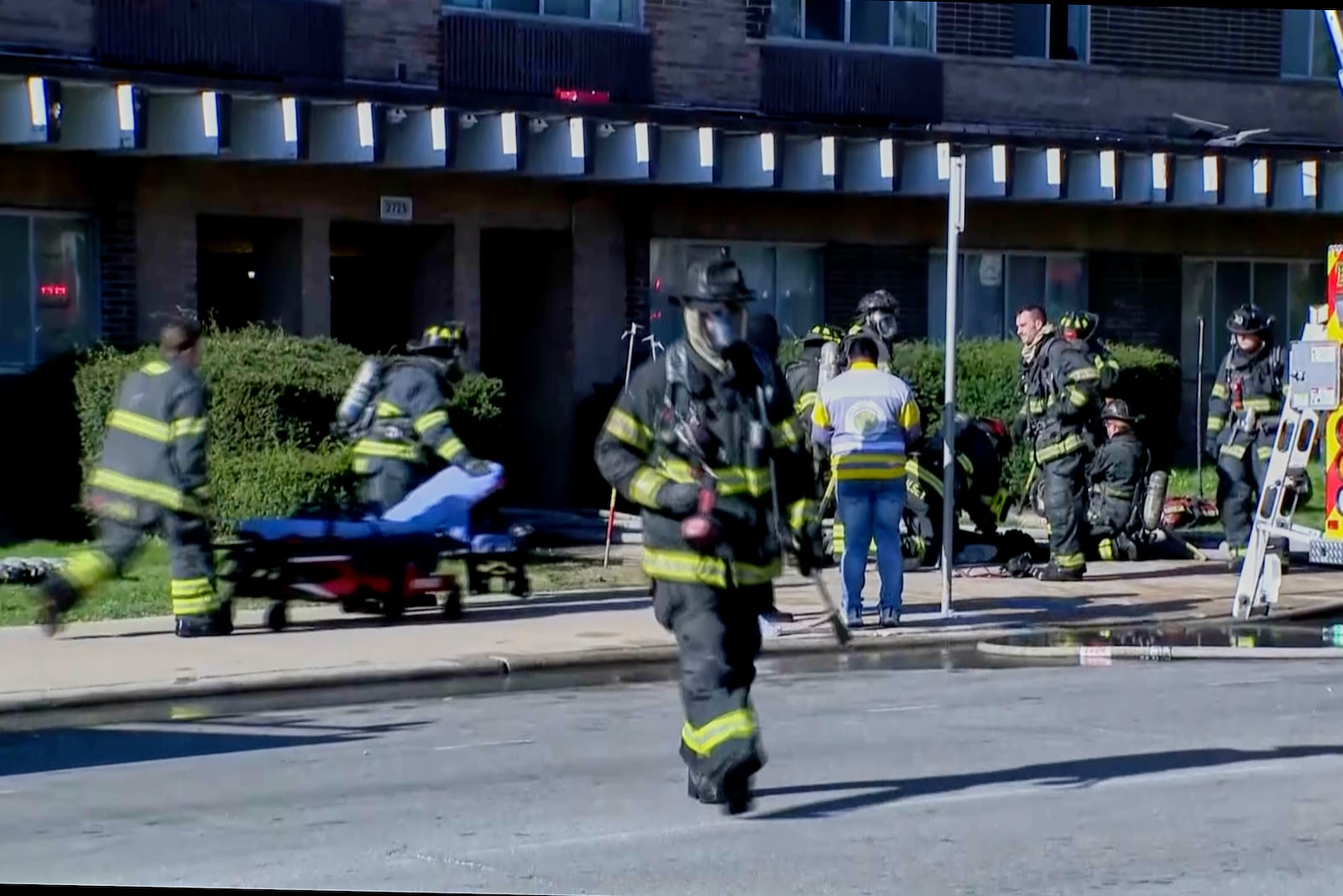 This image taken from video provided by WISN shows firefighters working at the site of an apartment building fire in Milwaukee, Wis., Sunday, May 11, 2025. (WISN via AP)
