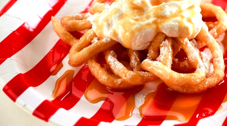 Funnel cakes are made by pouring batter into hot cooking oil in a circular pattern and deep frying the overlapping mass until golden-brown, like this Carmel Funnel Cake. The batter is commonly poured through a funnel creating its texture and giving its name. (Kirk McKoy/Los Angeles Times/TNS)