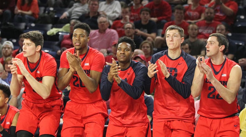 Dayton players (left to right: Sam Miller, Xeyrius Williams, John Crosby, Ryan Mikesell and Bobby Wehrli) cheer after a made free throw against Richmond on Tuesday, March 1, 2016, at the Robins Center in Richmond, Va. David Jablonski/Staff