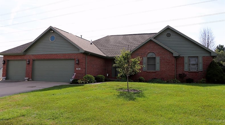 The 3-bedroom brick ranch with about 1,720 sq. ft. of living space sits on just under a half-acre property on a cul-de-sac. A concrete driveway leads to the 3-car garage and continues to the side for an extra, off-street parking pad. CONTRIBUTED PHOTO BY KATHY TYLER