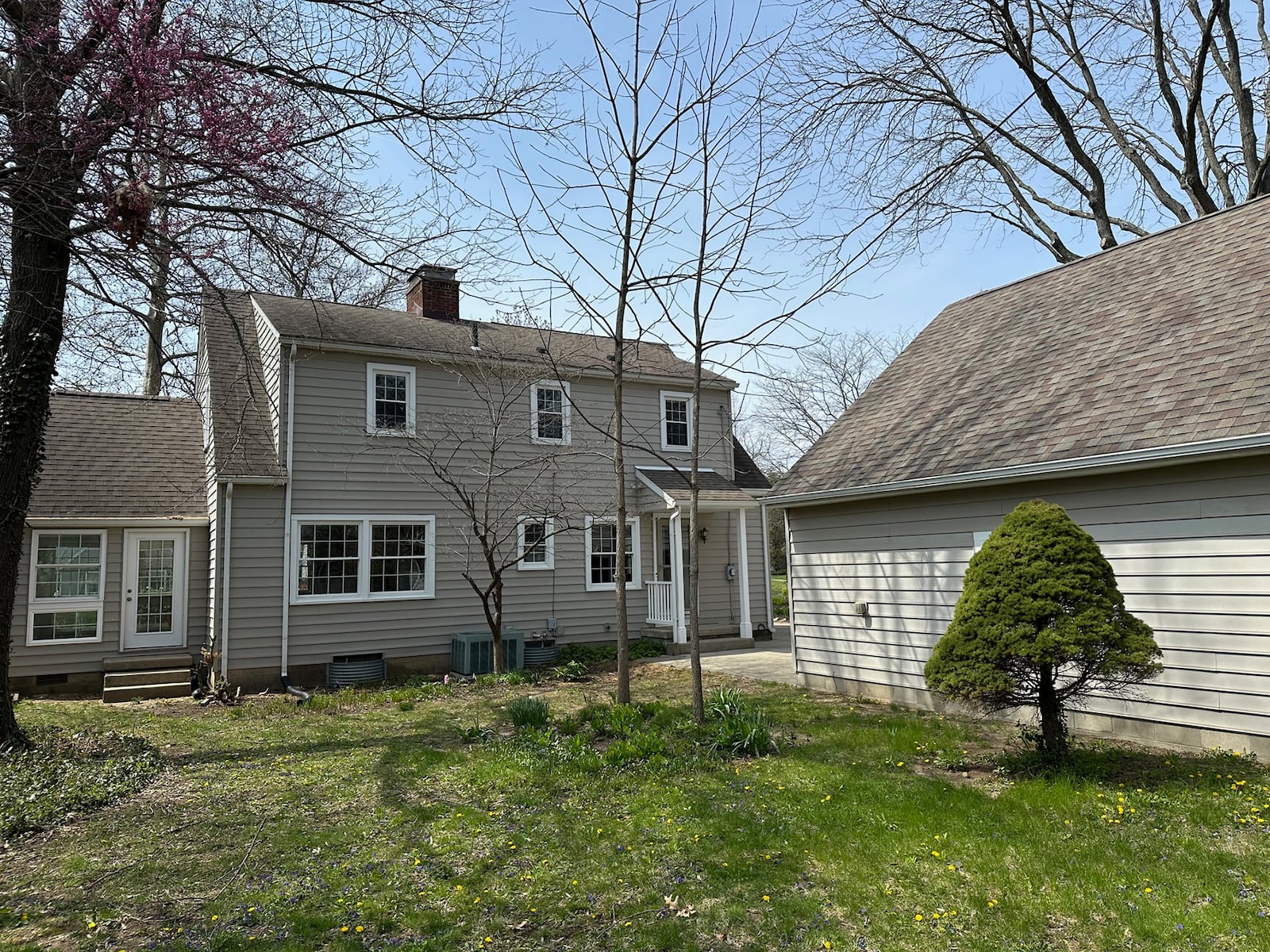 The rear of the home features a covered back porch and a wood privacy fence.