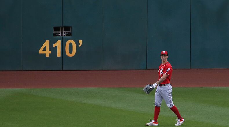 Cincinnati Reds’ Michael Lorenzen, a pitcher who pitched the fifth inning for the Reds, smiles as he takes his spot in center field during the sixth inning of a spring training baseball game against the Cleveland Indians Monday, March 11, 2019, in Goodyear, Ariz. (AP Photo/Ross D. Franklin)