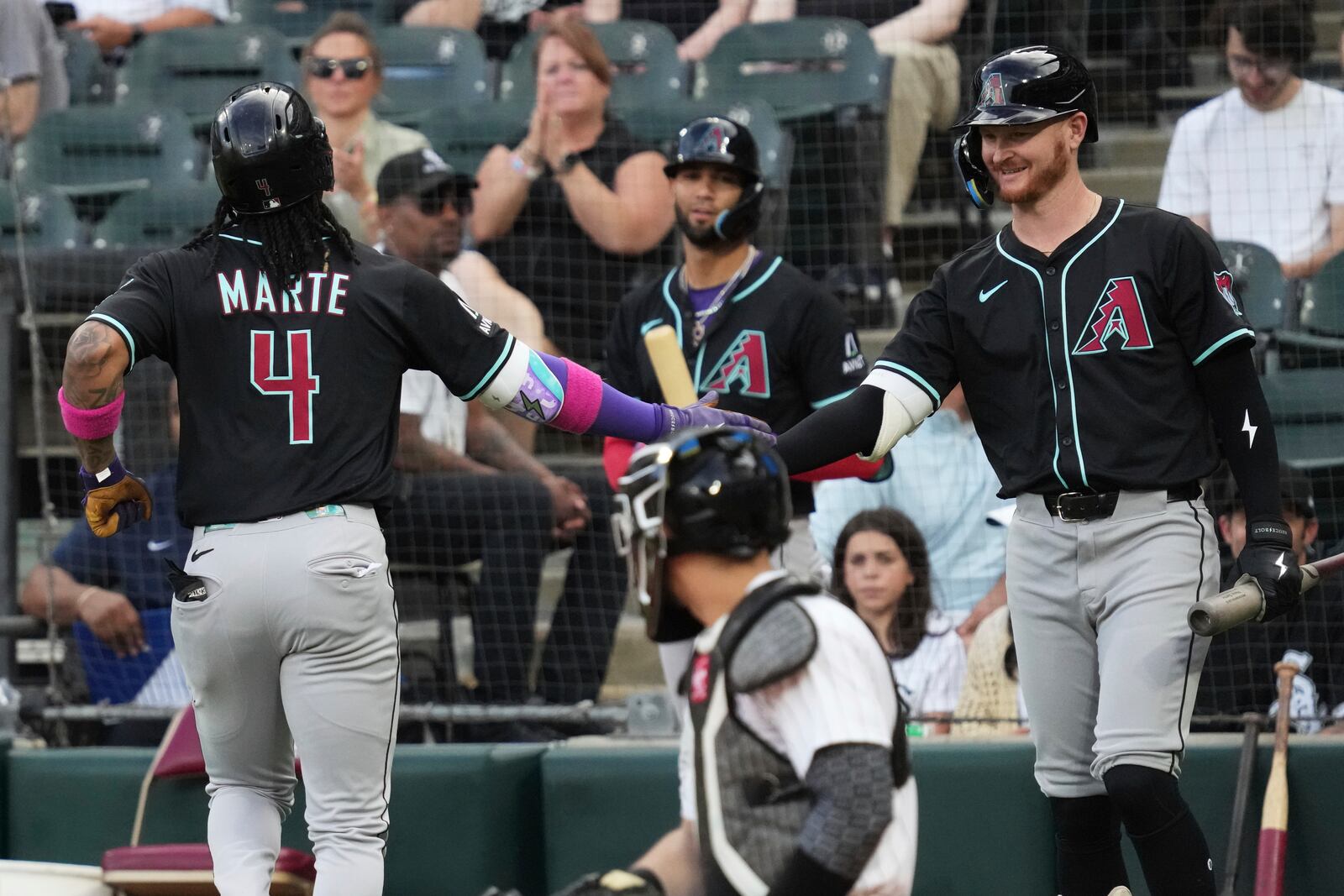 Arizona Diamondbacks' Ketel Marte (4) celebrates with Pavin Smith after hitting a solo home run during the first inning of a baseball game against the Chicago White Sox in Chicago, Tuesday, June 24, 2025. (AP Photo/Nam Y. Huh)