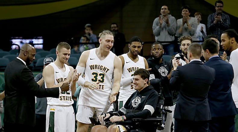 Ryan Custer is congratulated by teammates during senior recognition after Wright State’s game against IUPUI at the Nutter Center in Fairborn on Sunday, Feb. 16, 2020. Contributed photo by E.L. Hubbard