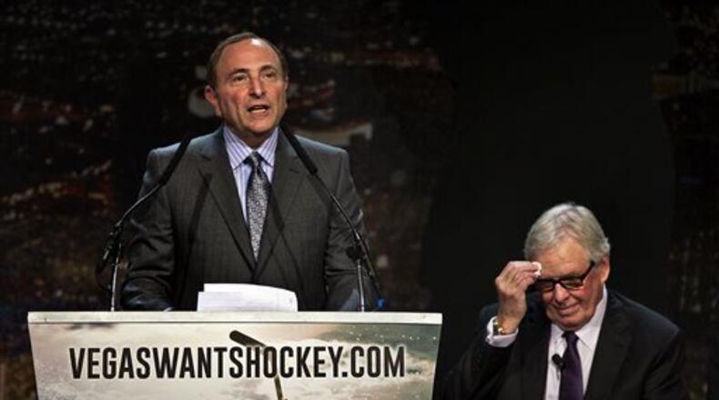 FILE - In this Feb. 10, 2015, file photo, Gary Bettman, commissioner of the National Hockey League addresses the crowd as Bill Foley, chairman, Fidelity National Financial, Inc., Black Knight and FIS wipes his forehead during the "Let's Bring Hockey to Las Vegas!" press conference at the MGM Grand Ballroom in Las Vegas. A person with direct knowledge of the NHL's decision says the league has settled on Las Vegas as its choice for expansion, provided organizers can come up with a $500 million fee. The person spoke Tuesday, June 14, 2016, on condition of anonymity because details have not been released by the league ahead of its Board of Governors meeting on June 22. (AP Photo/The Sun, L.E. Baskow, File ) LAS VEGAS REVIEW-JOURNAL OUT