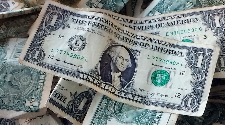 FILE - Dollar bills are shown in New York, Oct. 24, 2016. (AP Photo/Mark Lennihan, File)