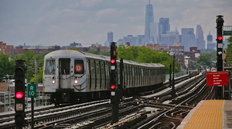 FILE - A subway approaches an above ground station in the Brooklyn borough of New York with the New York City skyline in the background, June 21, 2017. (AP Photo/Bebeto Matthews, File)