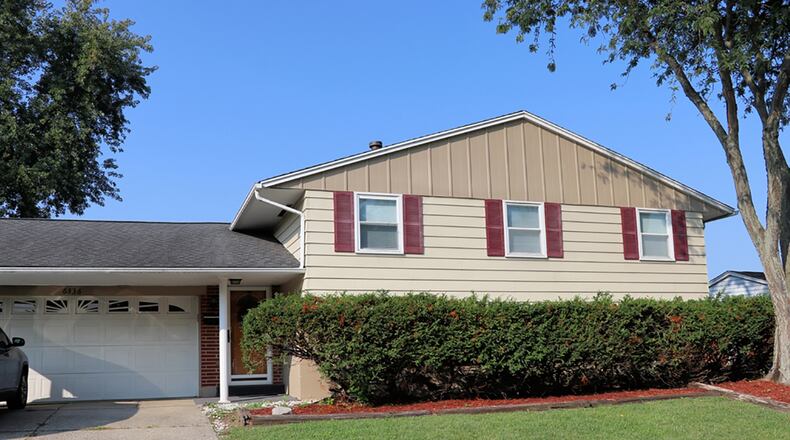 The brick-and-vinyl house has about 1,980 sq. ft. of living space with 3 bedrooms and 3 full baths. The home includes a two-car, attached garage and a multi-level wooden deck that wraps around an above-ground swimming pool. CONTRIBUTED PHOTO BY KATHY TYLER