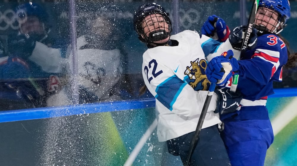 United States' Abbey Murphy, right, checks Finland's Julia Schalin during a preliminary round match of women's ice hockey between the United States and Finland at the 2026 Winter Olympics, in Milan, Italy, Saturday, Feb. 7, 2026. (AP Photo/Petr David Josek)