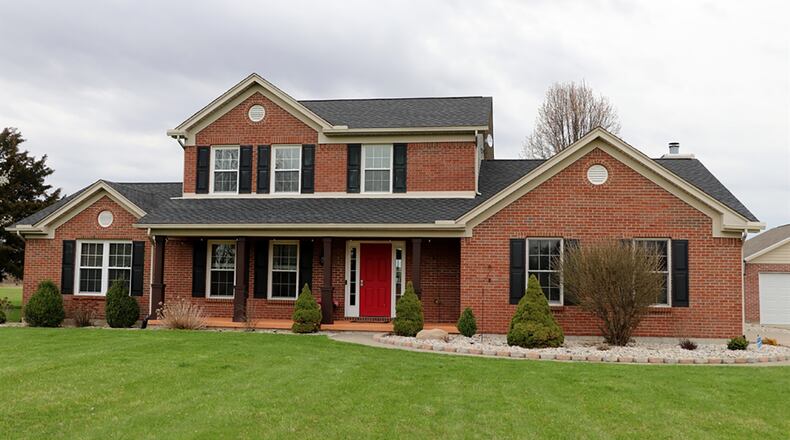 The brick house has about 2,410 sq. ft. of living space, including a first-floor main bedroom suite. The 2.1-acre property includes a 2-car, detached garage. CONTRIBUTED PHOTO BY KATHY TYLER