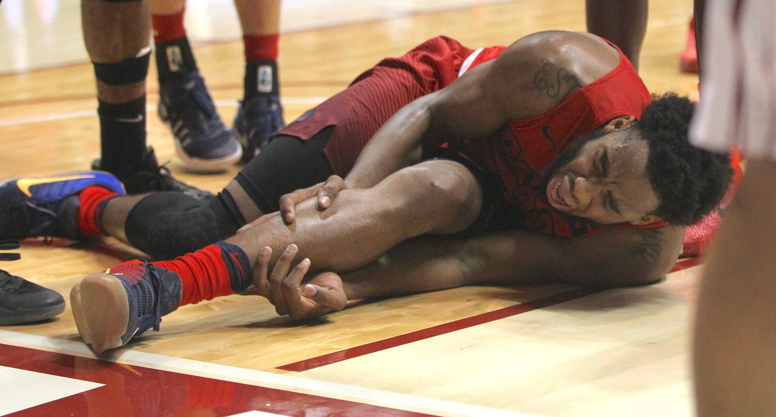 Josh Cunningham writhes in pain after his injury Tuesday. David Jablonski/Staff