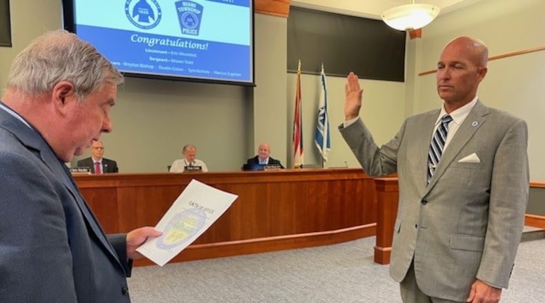 Miami Twp. Fiscal Officer Bob Matthews (left) swears in Doug Barry (right) as the township's newest trustee Monday, Oct. 28, 2024. Barry previously served as trustee from April 2014 until December 2019. CONTRIBUTED