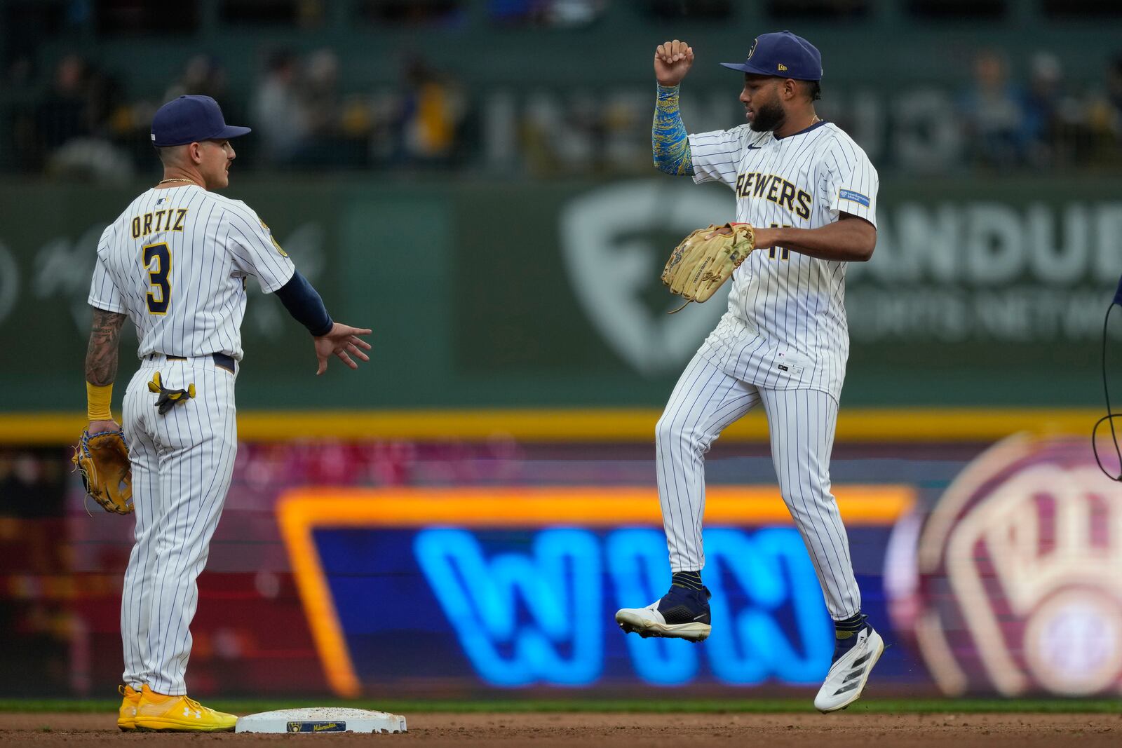 Milwaukee Brewers' Jackson Chourio, right, celebrates with Joey Ortiz, left, after a baseball game against the Cincinnati Reds, Sunday, April 6, 2025, in Milwaukee. (AP Photo/Aaron Gash)