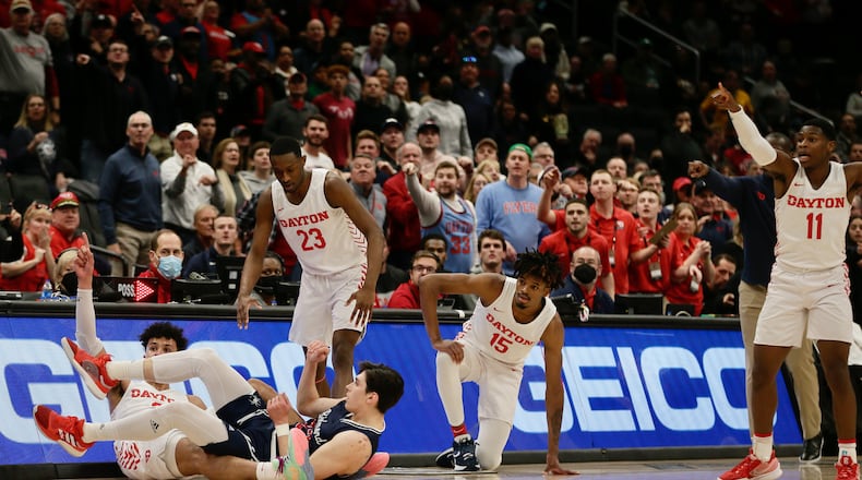Dayton and Richmond go after a loose ball in the semifinals of the Atlantic 10 Conference tournament on Saturday, March 12, 2022, at Capital One Arena in Washington, D.C. David Jablonski/Staff