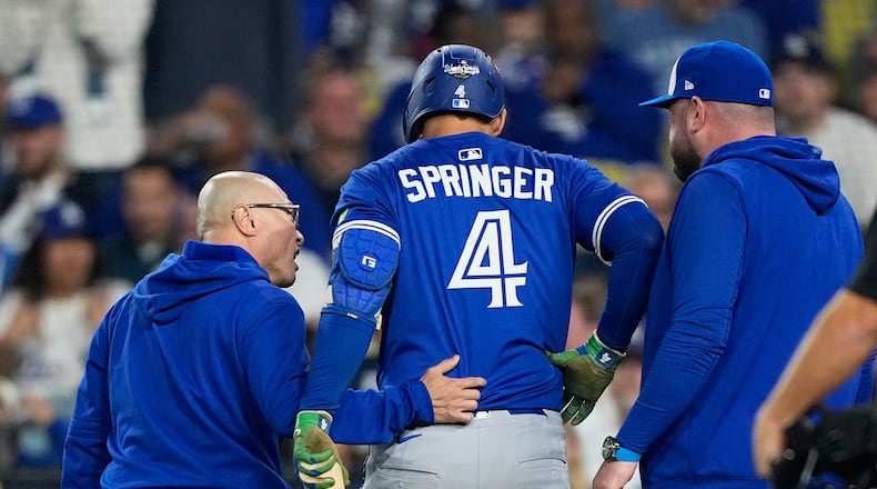 Toronto Blue Jays' George Springer leaves the game with an injury during the seventh inning in Game 3 of baseball's World Series against the Los Angeles Dodgers, Monday, Oct. 27, 2025, in Los Angeles. (AP Photo/Brynn Anderson)