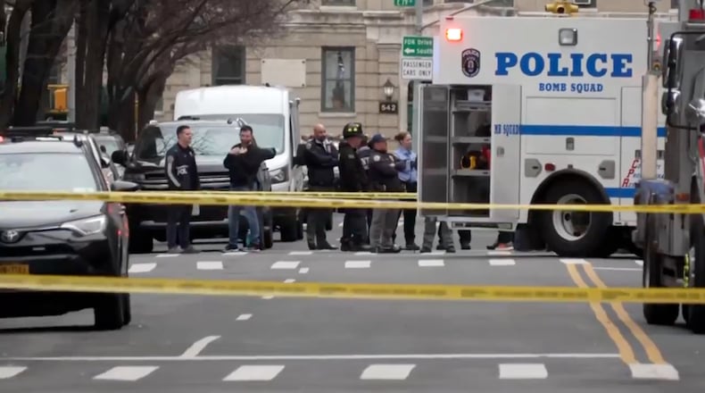 In this image taken from video, law enforcement officers respond to Manhattan's Upper East Side as New York City's police said they had identified a "suspicious device in a vehicle,” Sunday, March 8, 2026, in New York. (AP Photo/Joseph B. Frederick)