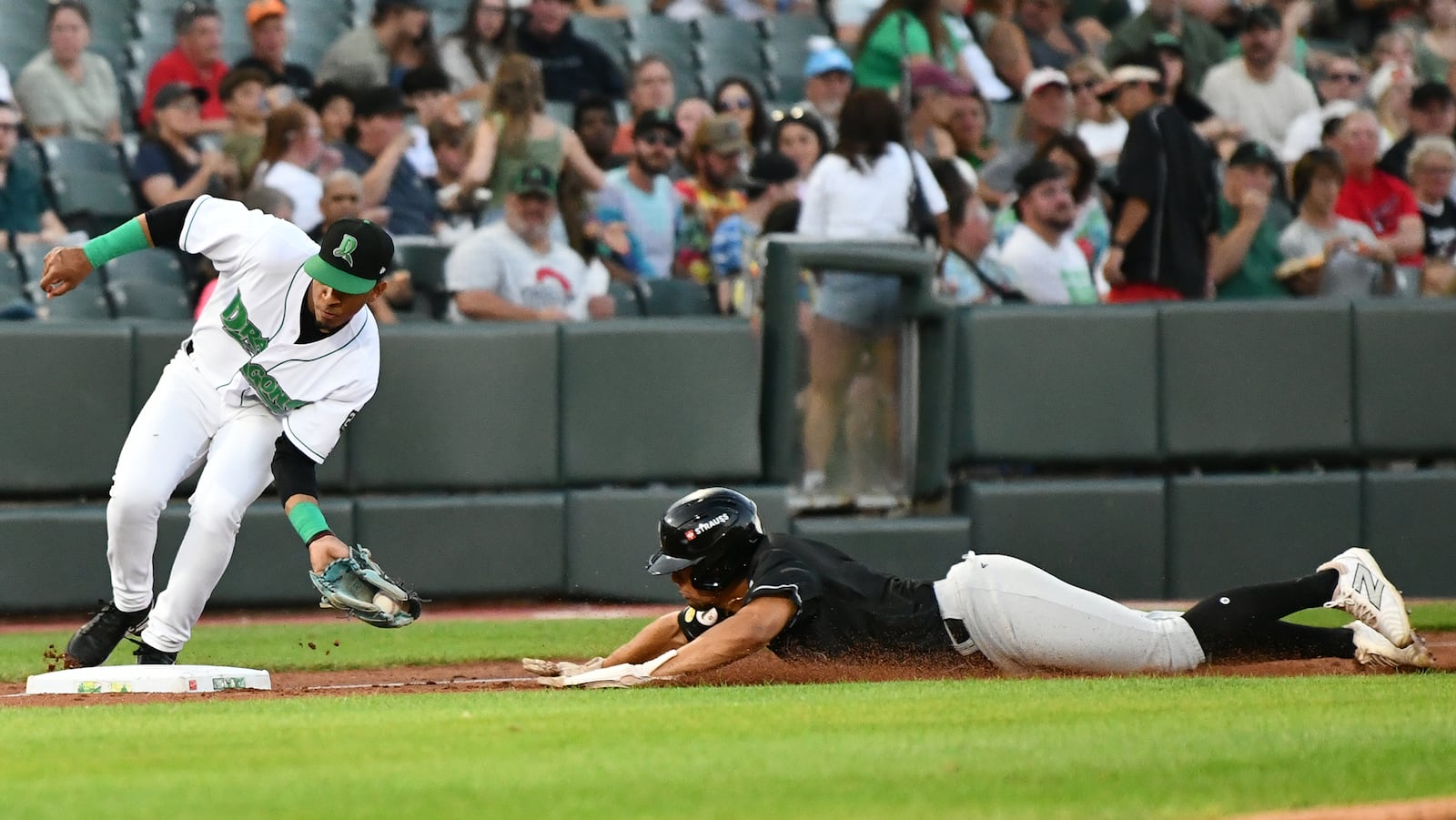 Carlos Sanchez tags out Ali Camarillo trying to steal third base in the eighth inning Tuesday night at Day Air Ballpark. Omana threw two others trying to steal second earlier in the game. JEFF GILBERT/CONTRIBUTED