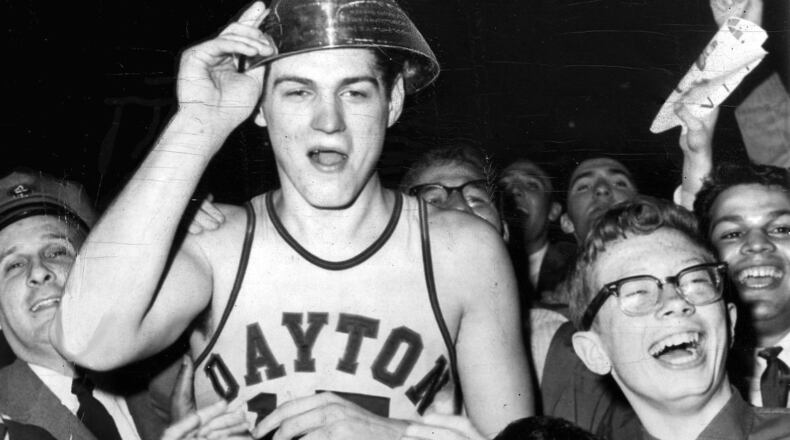 3-24-1962 NEW YORK: Bill Chmielewski, who led Dayton to a 73-67 victory over St. John’s in the finals of the National Invitation Basketball Tournament, is mobbed by delirious fans at the end of the game. On his head is the trophy he received as the most valuable player. UPI TELEPHOTO