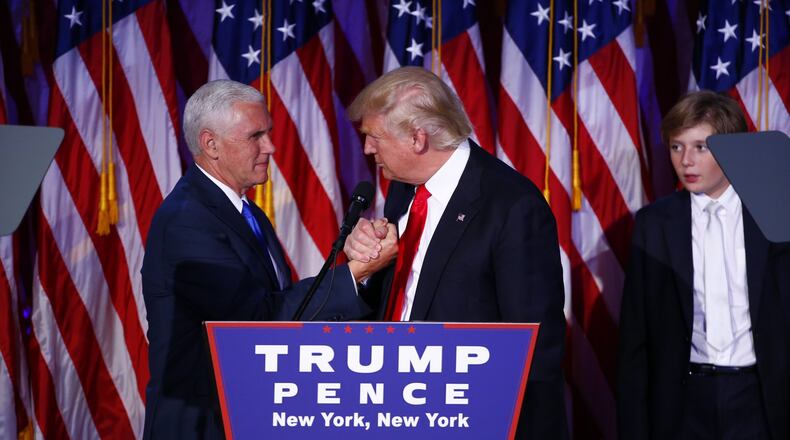 President-elect Donald Trump clasps hands with his running mate, Mike Pence at his victory speech, around 3 a.m. in New York, Nov. 9, 2016. Trump said that he had received a phone call of congratulations from Hillary Clinton. (Eric Thayer/The New York Times)