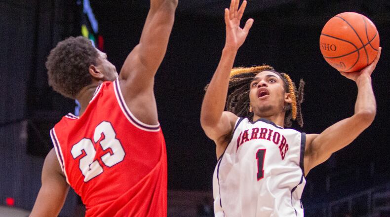 Wayne's Lawrent Rice shoots over Fairfield's Mason King during Saturday's Division I district final at UD Arena. CONTRIBUTED/Jeff Gilbert