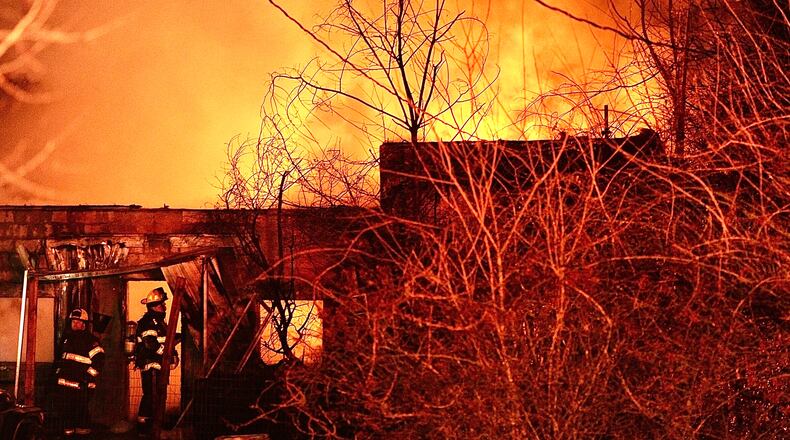 Flames roar in the night sky during a house fire on Cherry Drive in Springfield Township on Sunday, Dec. 18, 2022. Two firefighters suffered non-life-threatening injuries, and 13 dogs were killed. MARSHALL GORBY \STAFF