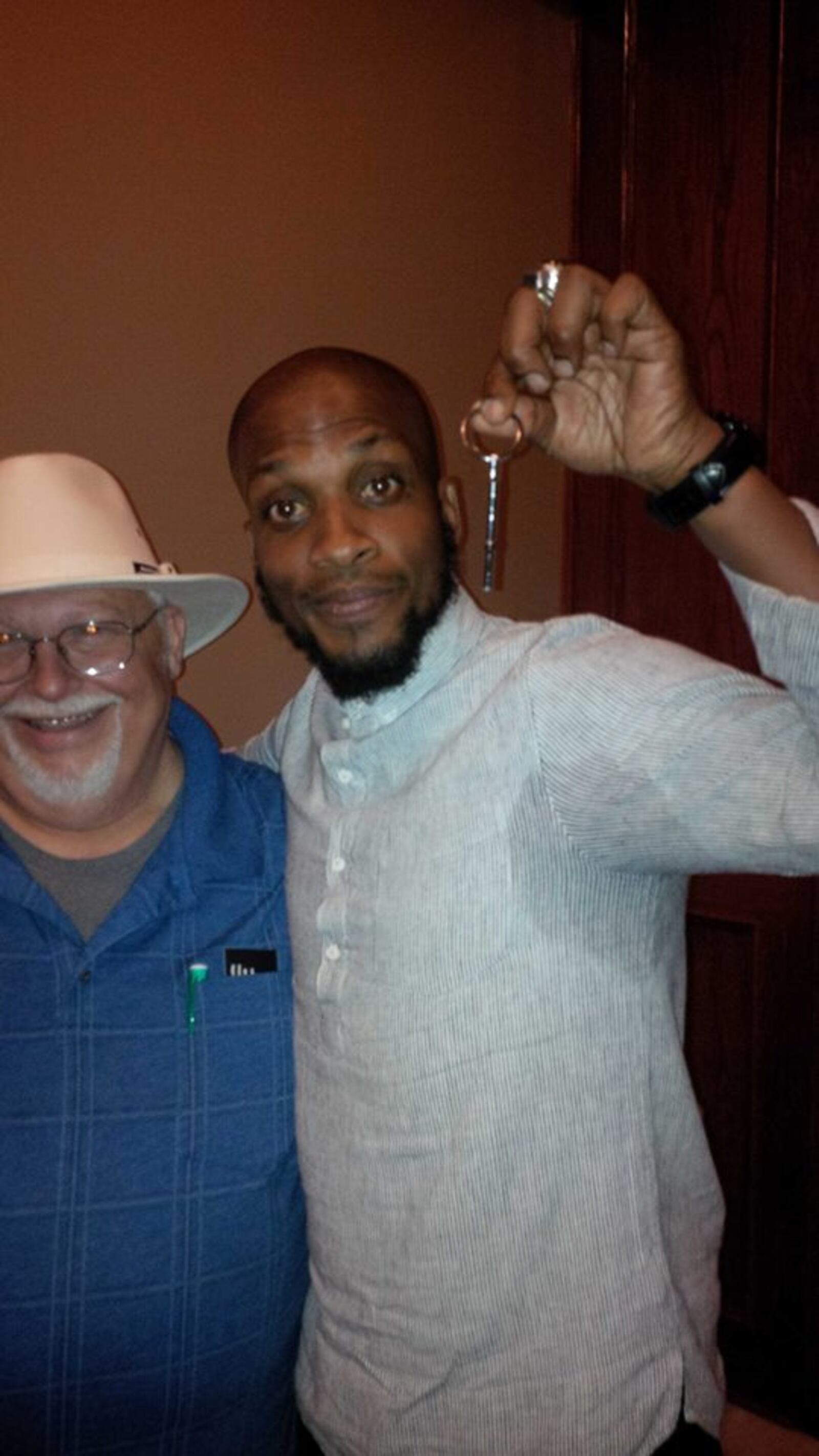 Cal Westray gives a key chain to comedian Ali Siddiq. CONTRIBUTED